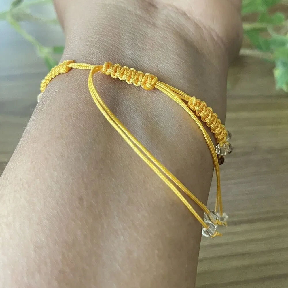 Yellow women's bracelet braided with crystals